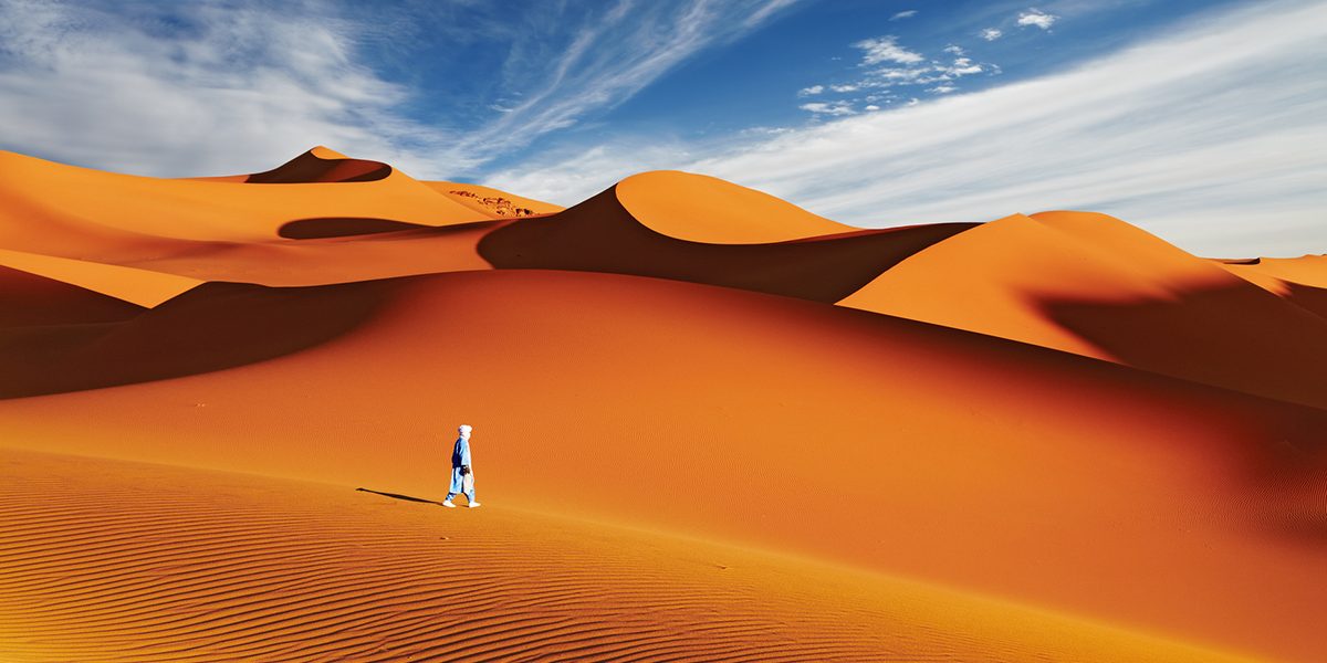 Person-walking-over-the-Sahara-Desert